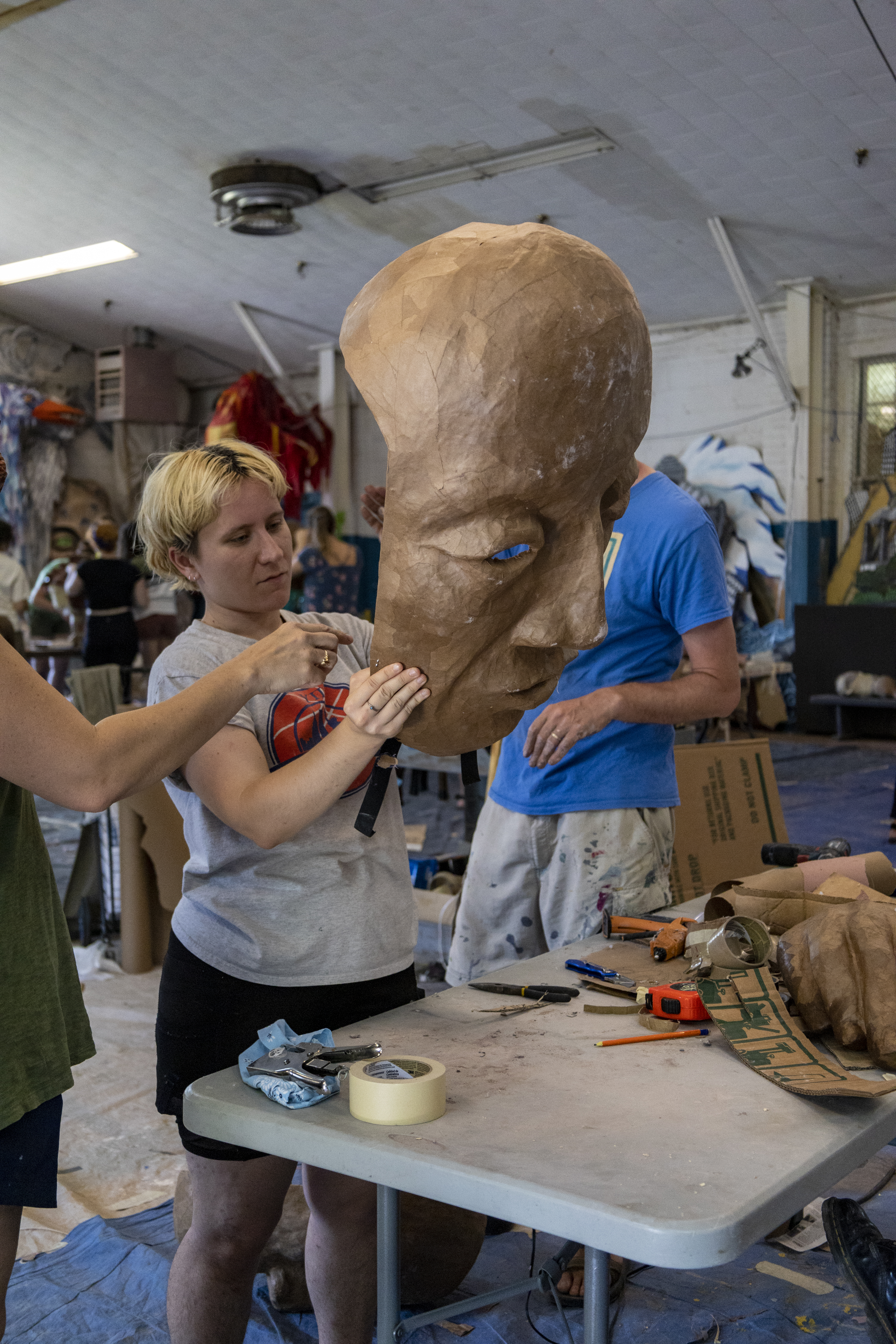 Xtian in the Paperhand studio working on a mask.